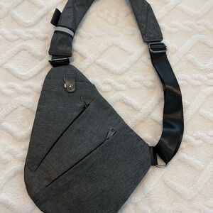 Ladies and Men's Gray Sling travel safety Bag. Lays close to body. Never used